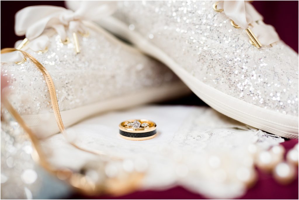 detail images of wedding rings and bridal keds shoes gold and maroon