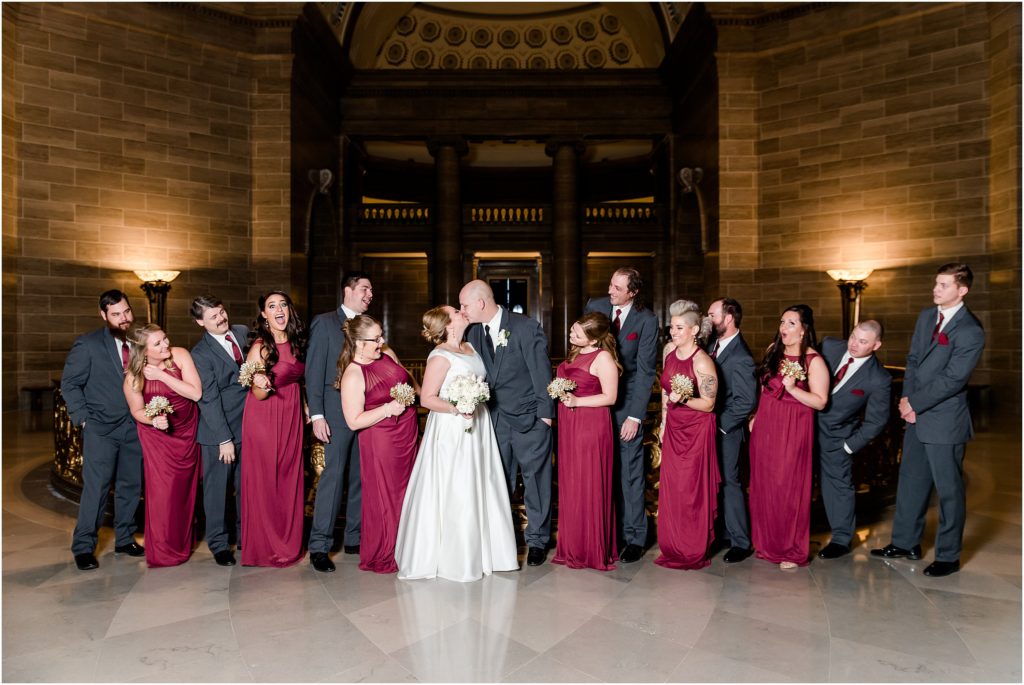 wedding party photo in missouri state capitol rotunda with maroon details