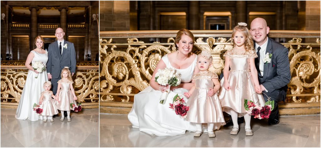 bride and groom posing with flower girls in gold dresses in missouri state capitol rotunda