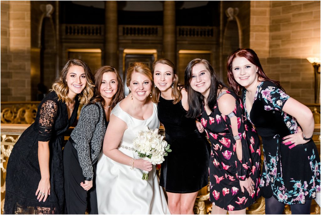 bride with girl cousins smiling for camera in missouri state capitol rotunda
