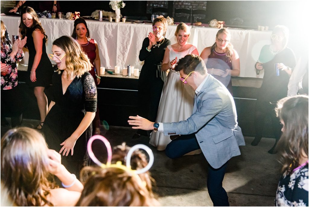 wedding guests dancing with glow necklaces during wedding reception at millbottom
