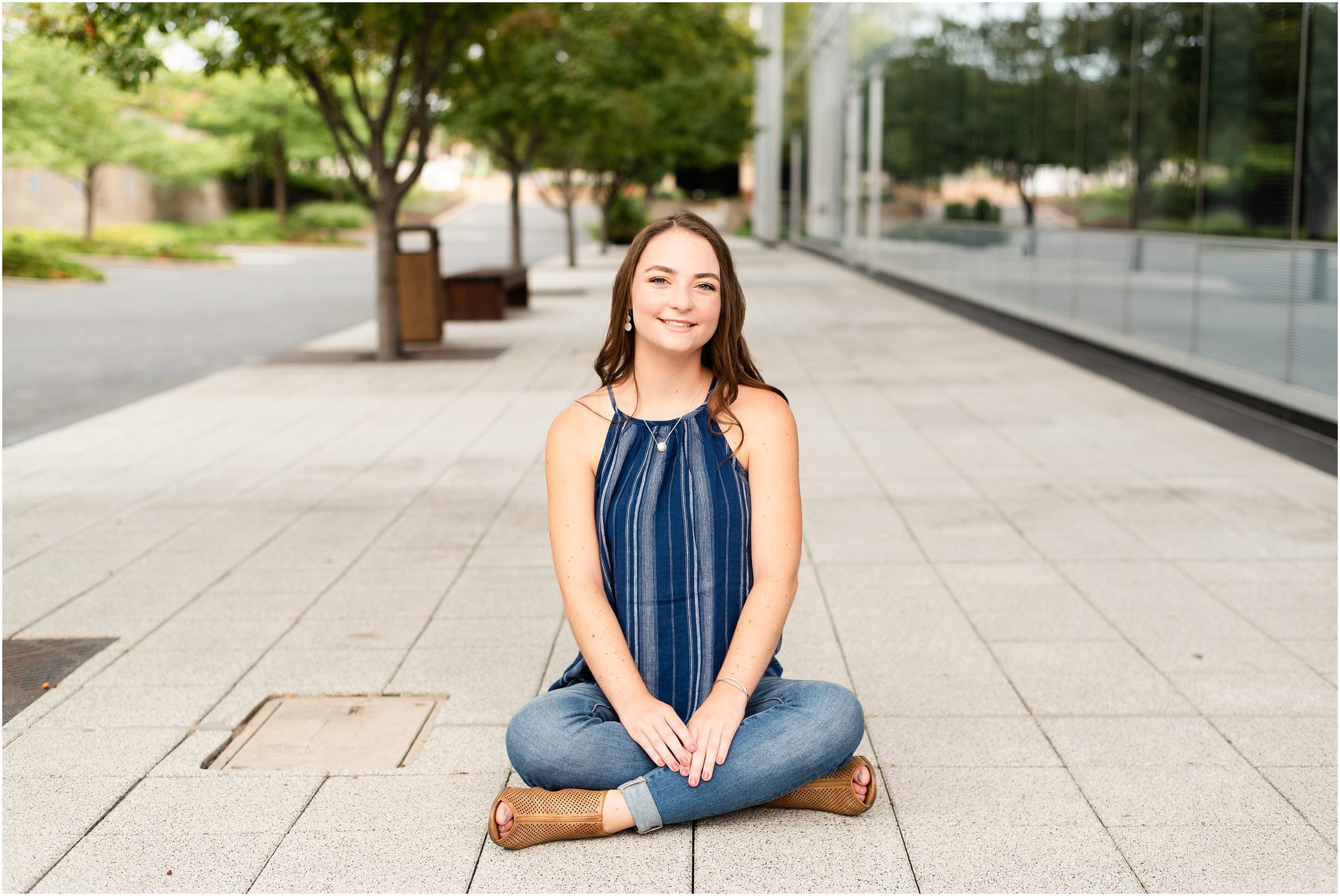 jchs senior session in downtown Jefferson City, mo for senior girl wearing blue shirt by central bank building