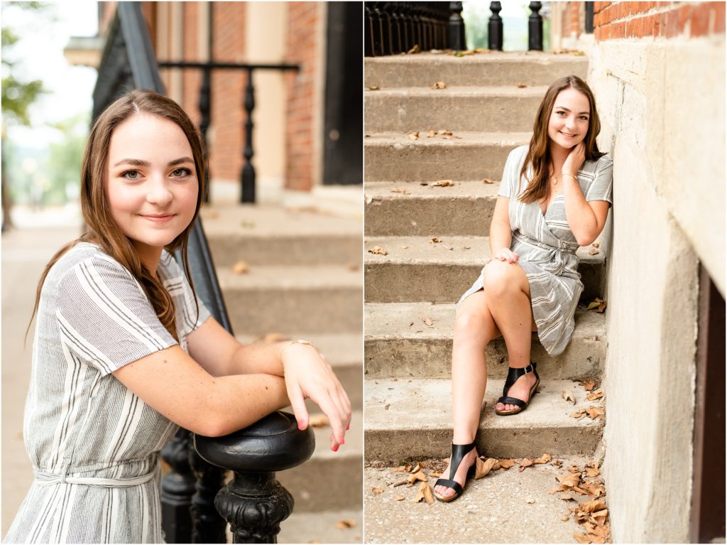 senior girl leaning against iron railing and concrete wall for senior photos in downtown Jefferson City, mo