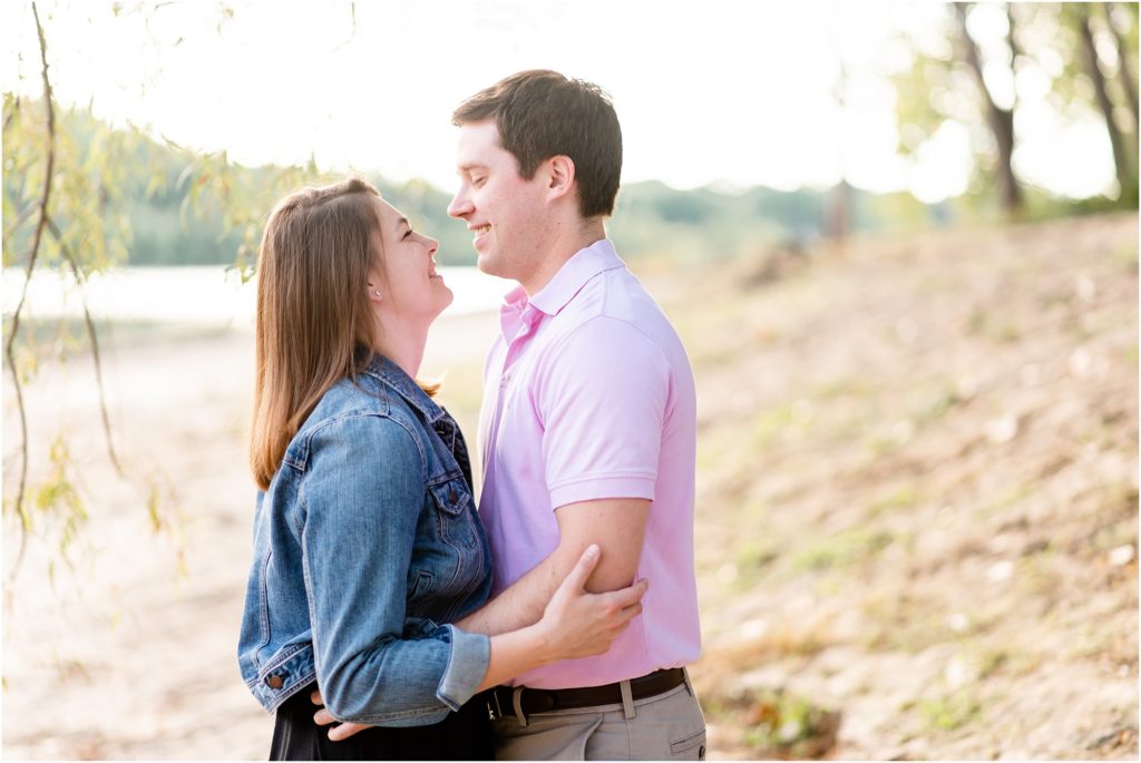 engaged couple smiling at each other on beach at Noren river access in Jefferson City, MO