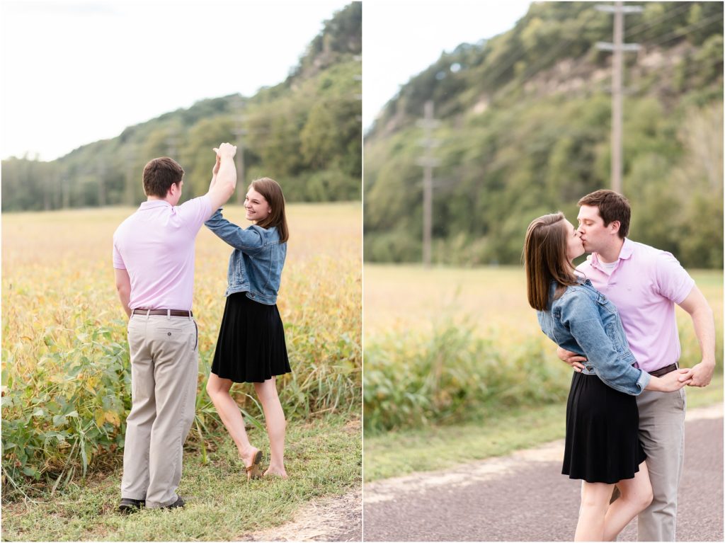 engaged couple kissing and twirling in field for engagement session