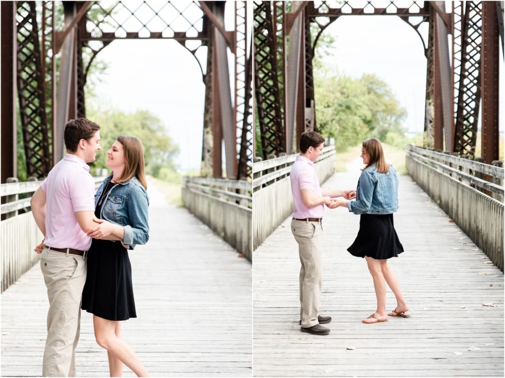 engaged couple laughing and dancing on Katy trail bridge for engagement pictures
