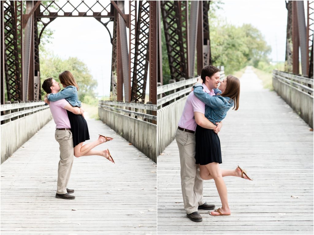 engaged couple holding each other on bridge on Katy trail in Jefferson City, mo