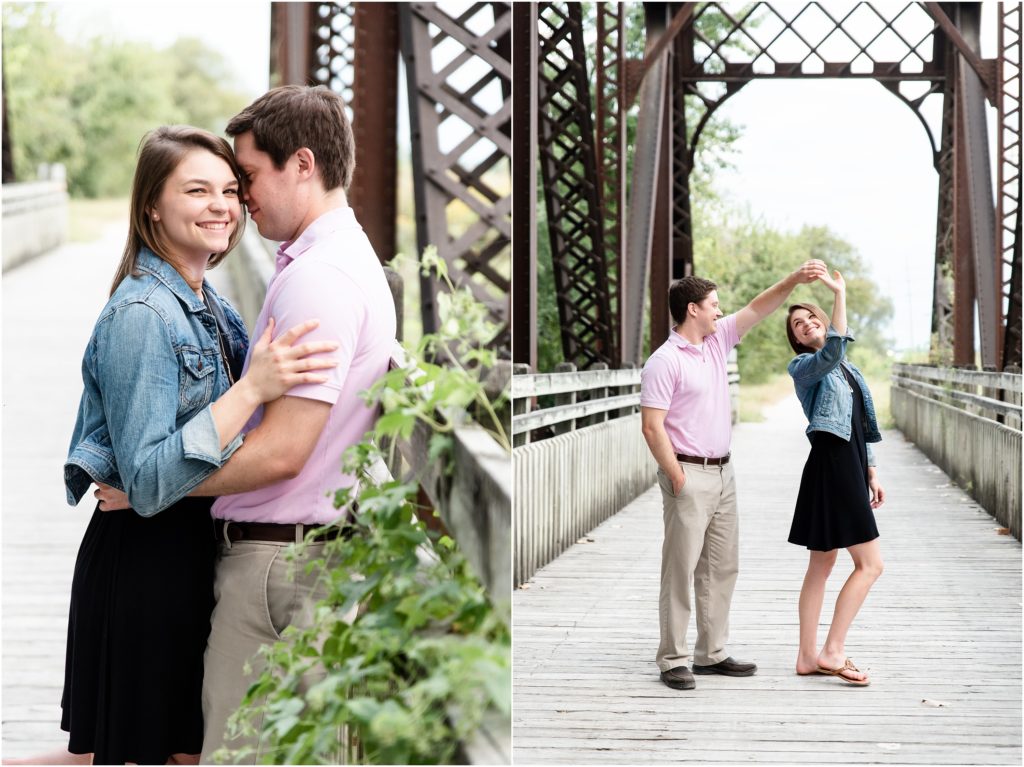 engaged couple spinning on bridge for engagement session