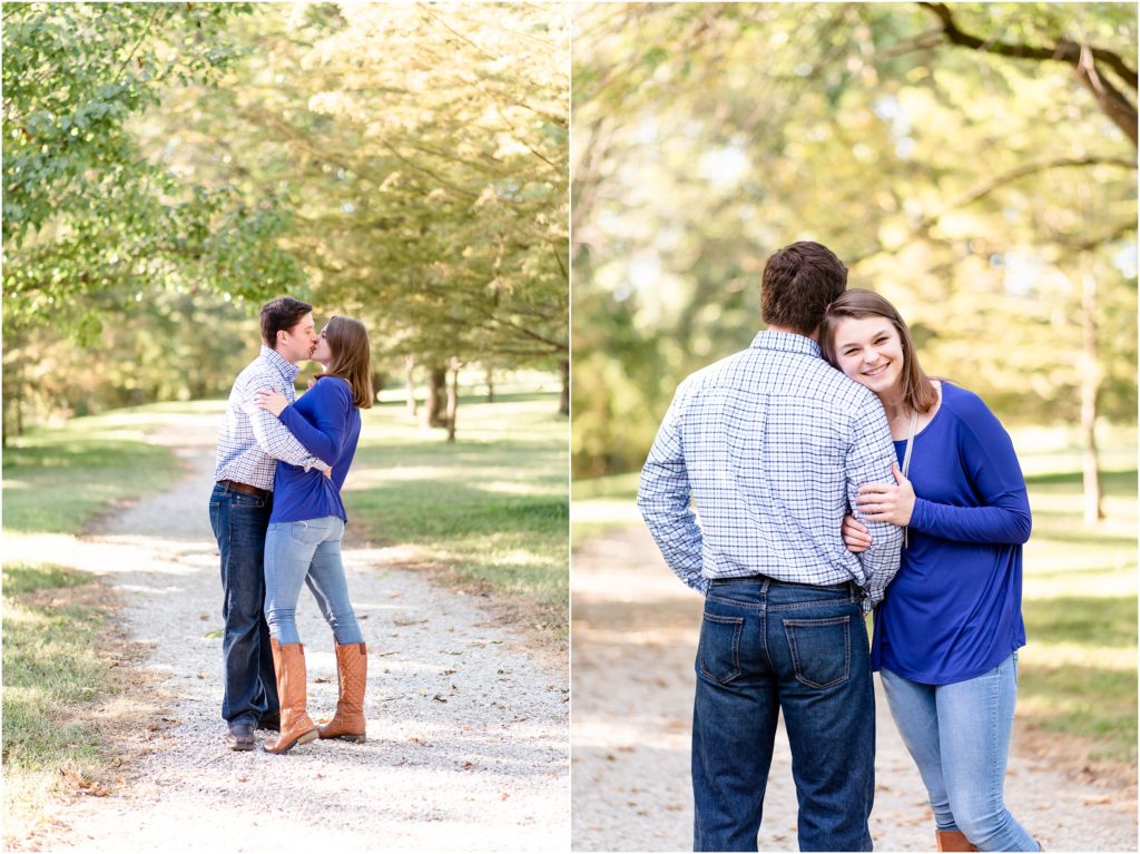 engaged couple kissing on path in park