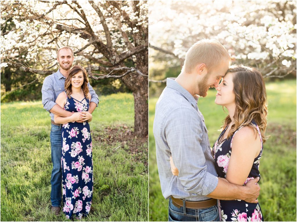 couple posing under white tree in sunlight for photos