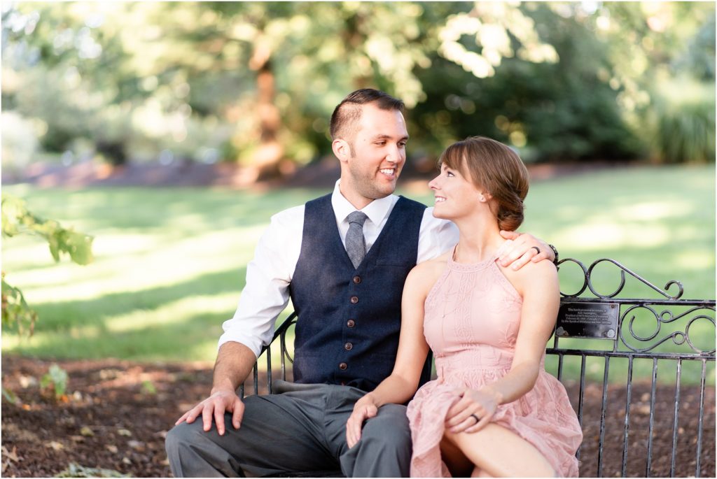 engaged couple sitting on shelter gardens park bench