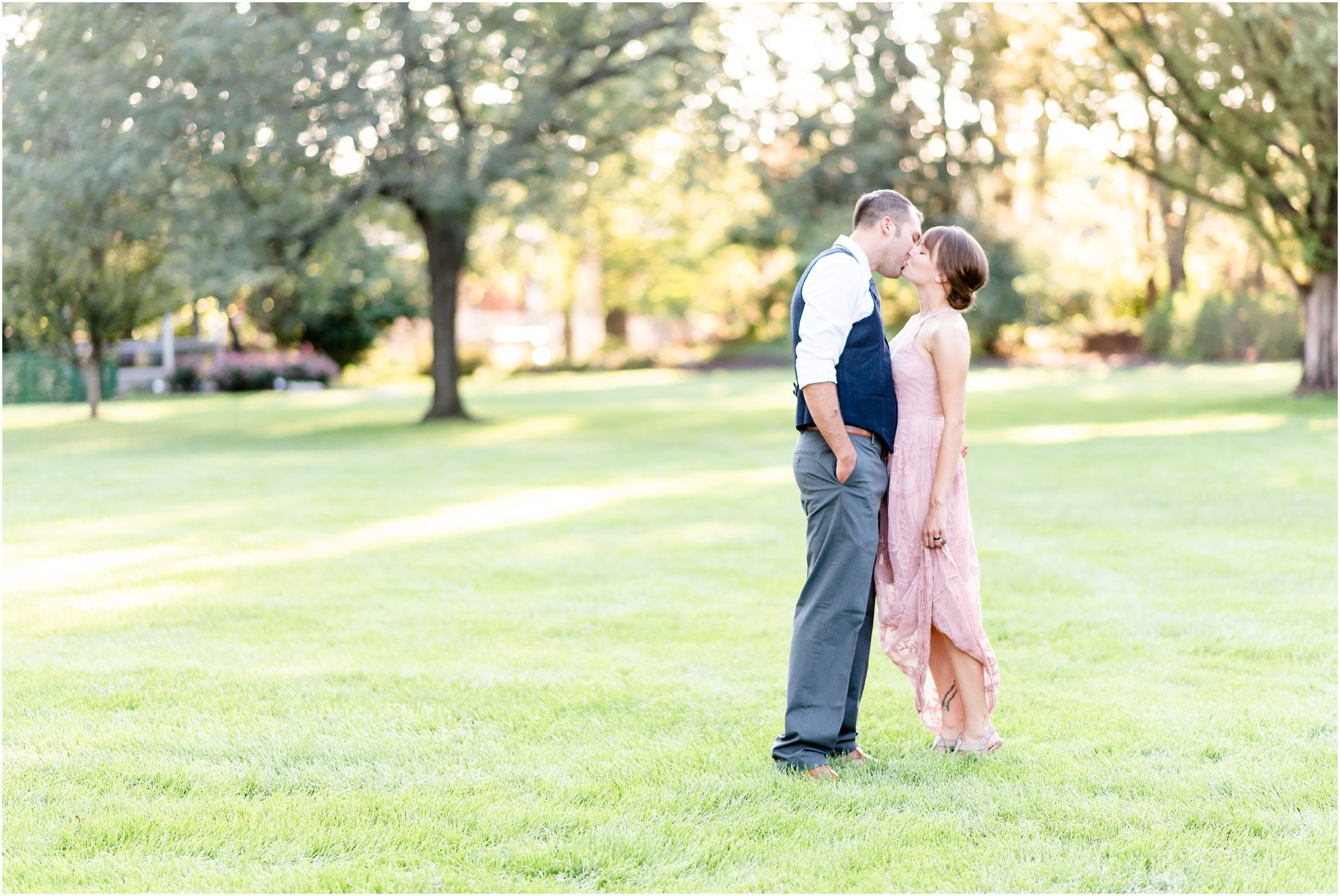 bride and groom dancing on the grass in shelter gardens park for a columbia, mo engagement session