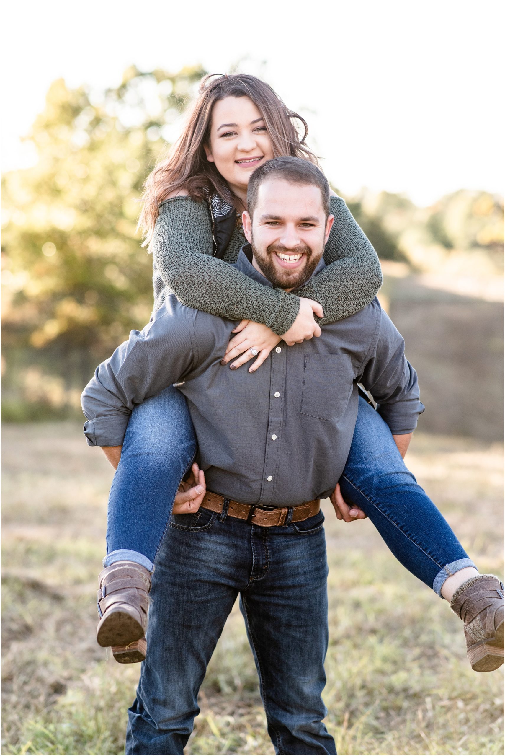 engaged couple doing piggy back ride during runge nature center engagement session