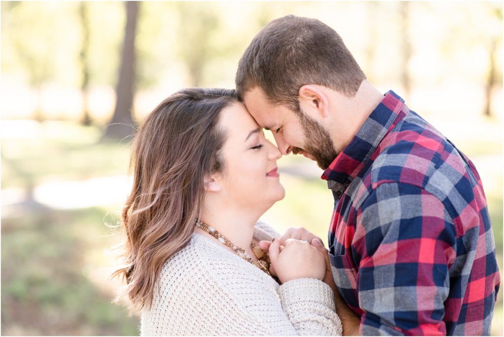 couple touching noses for engagement session at runge nature center