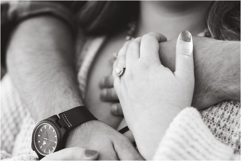 black and white image of couple holding hands and detail shot of engagement ring