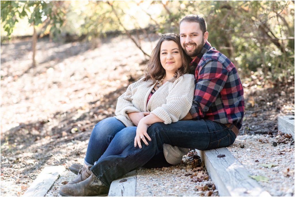 engaged couple sitting on stairs for runge nature center engagement session