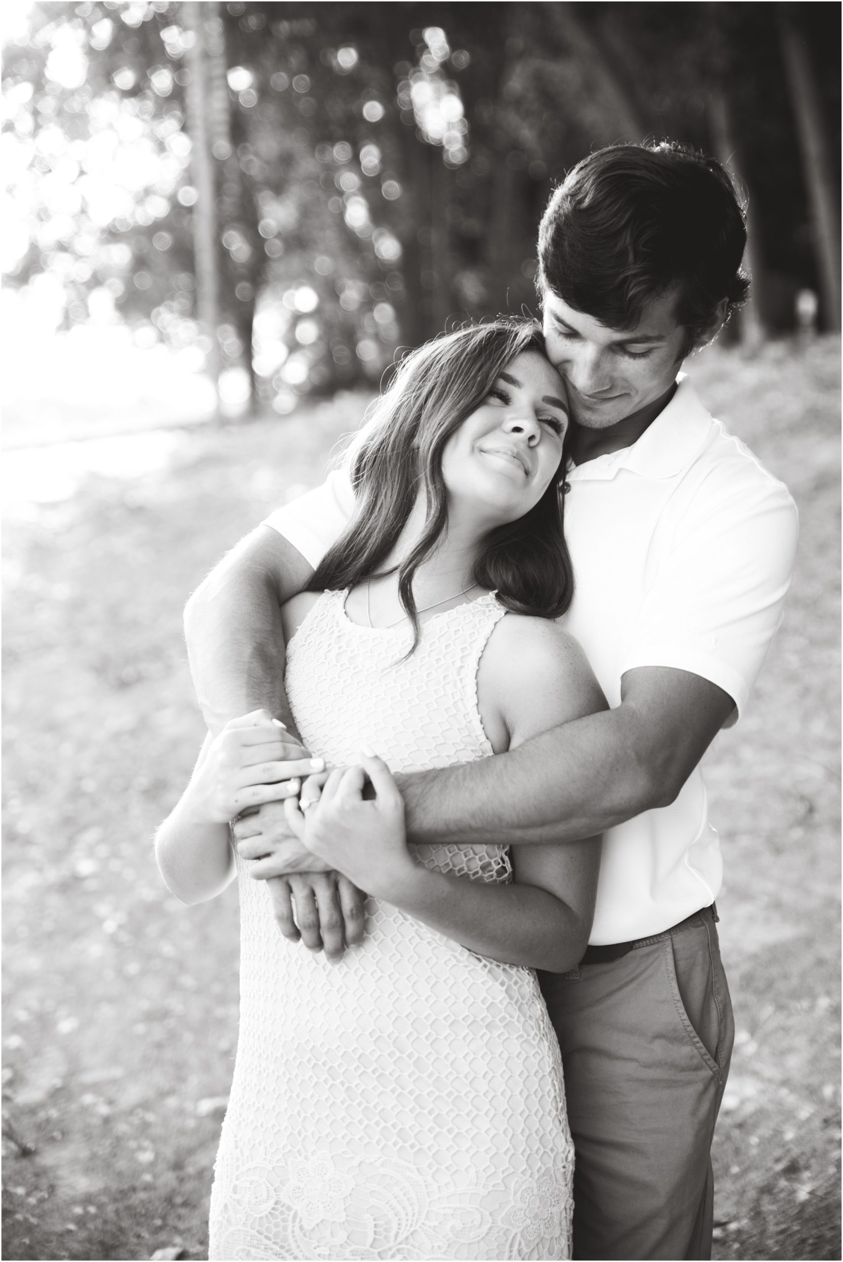 black and white image of couple cuddling on sand beach at Missouri river access jefferson city, mo engagement session