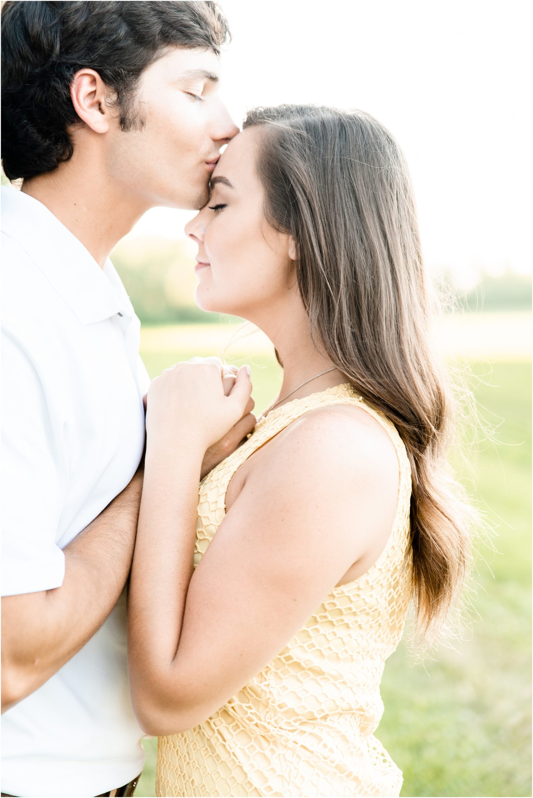 boy kissing forehead of fiancé for jefferson city mo engagement session photos