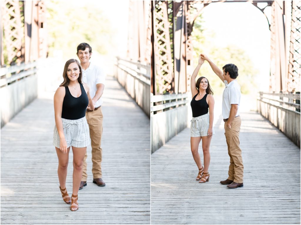 couple dancing and walking on bridge during engagement photos