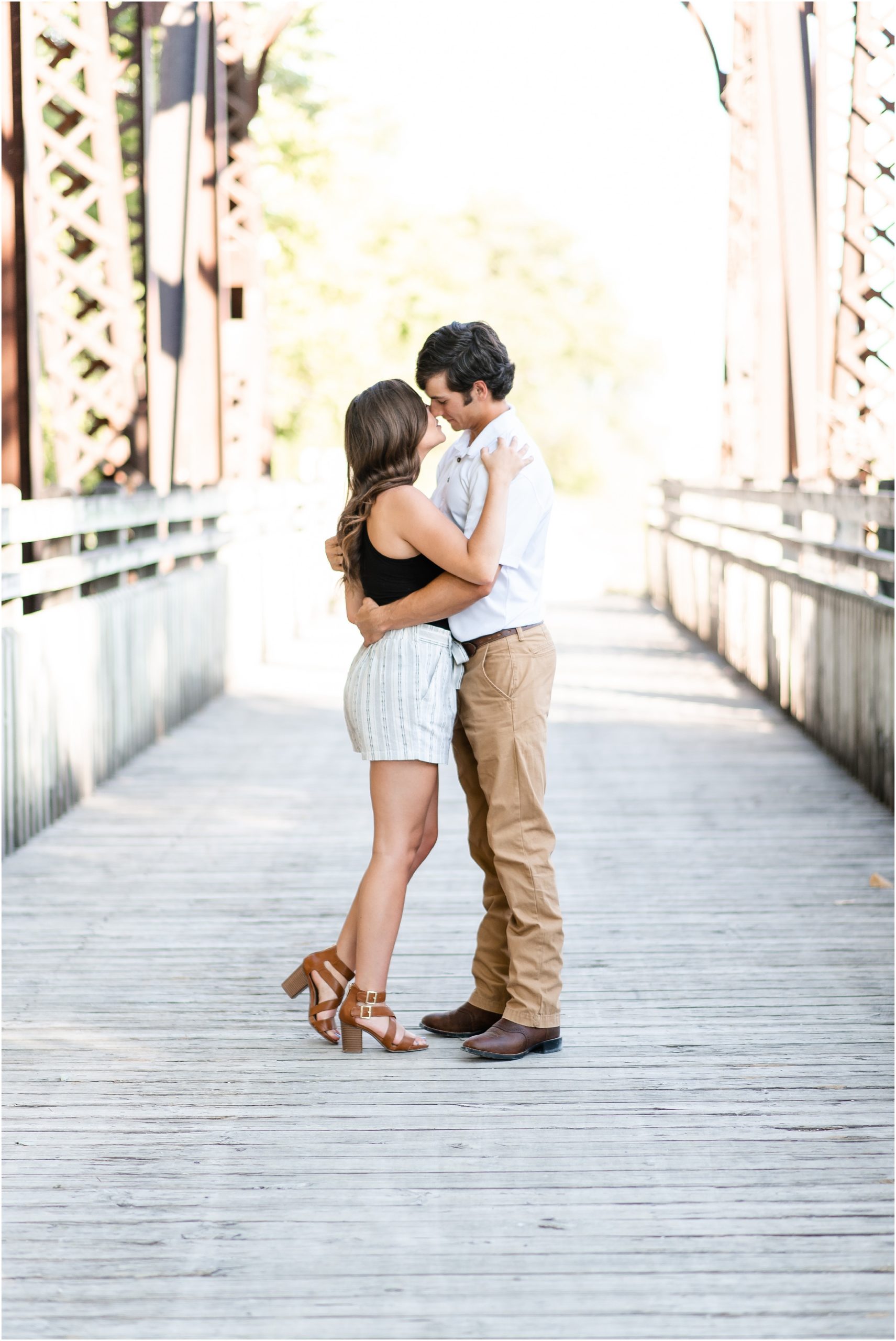 engaged couple kissing on bridge for jefferson city engagement session