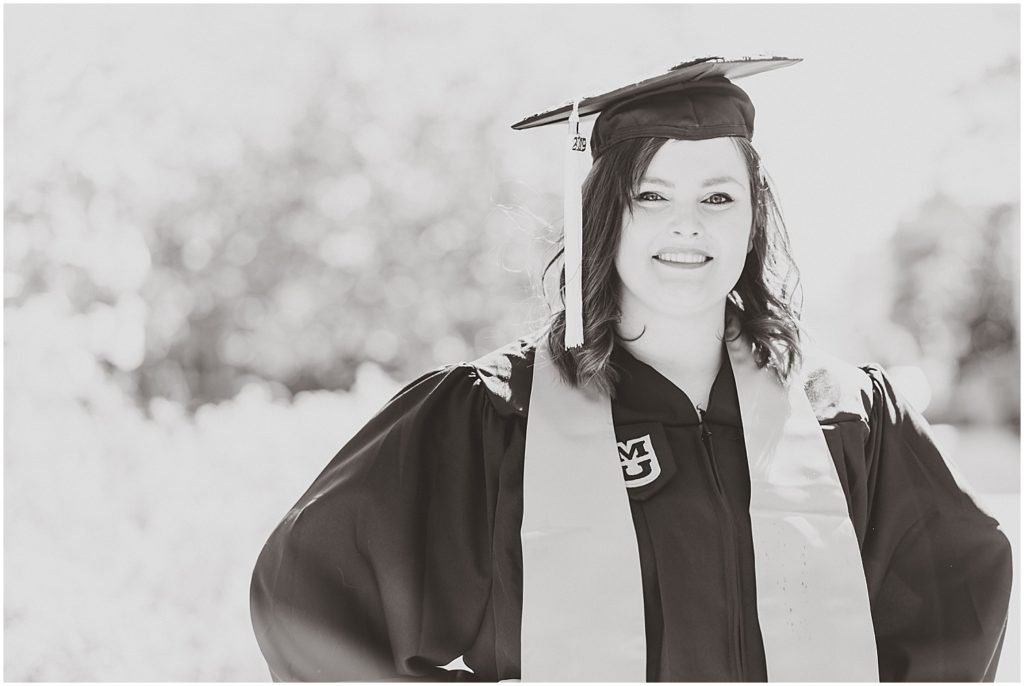 black and white image of mizzou senior in cap and gown