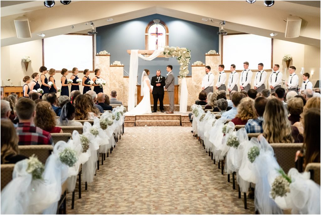 wide shot of church ceremony and all of the wedding party