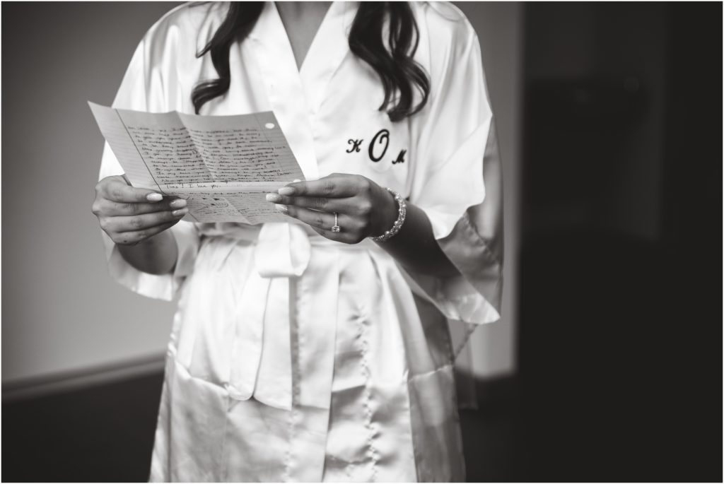 black and white image of bride reading letter