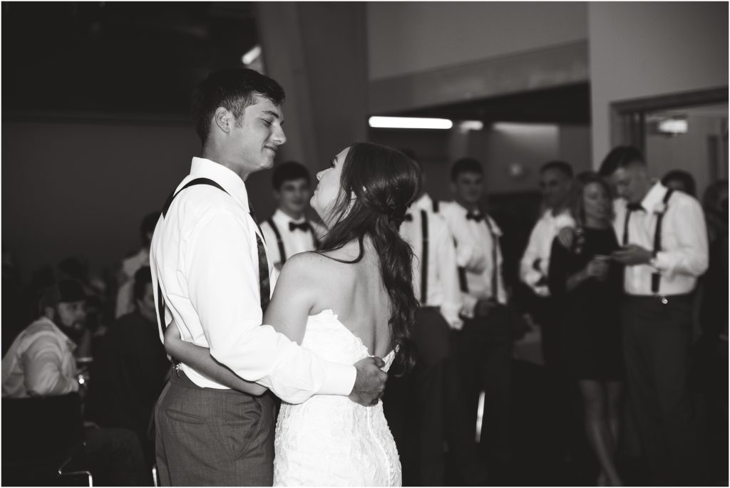 black and white image of bride and groom dancing first dance