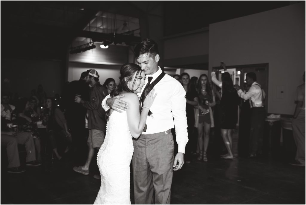 black and white image of bride and groom dancing during wedding reception