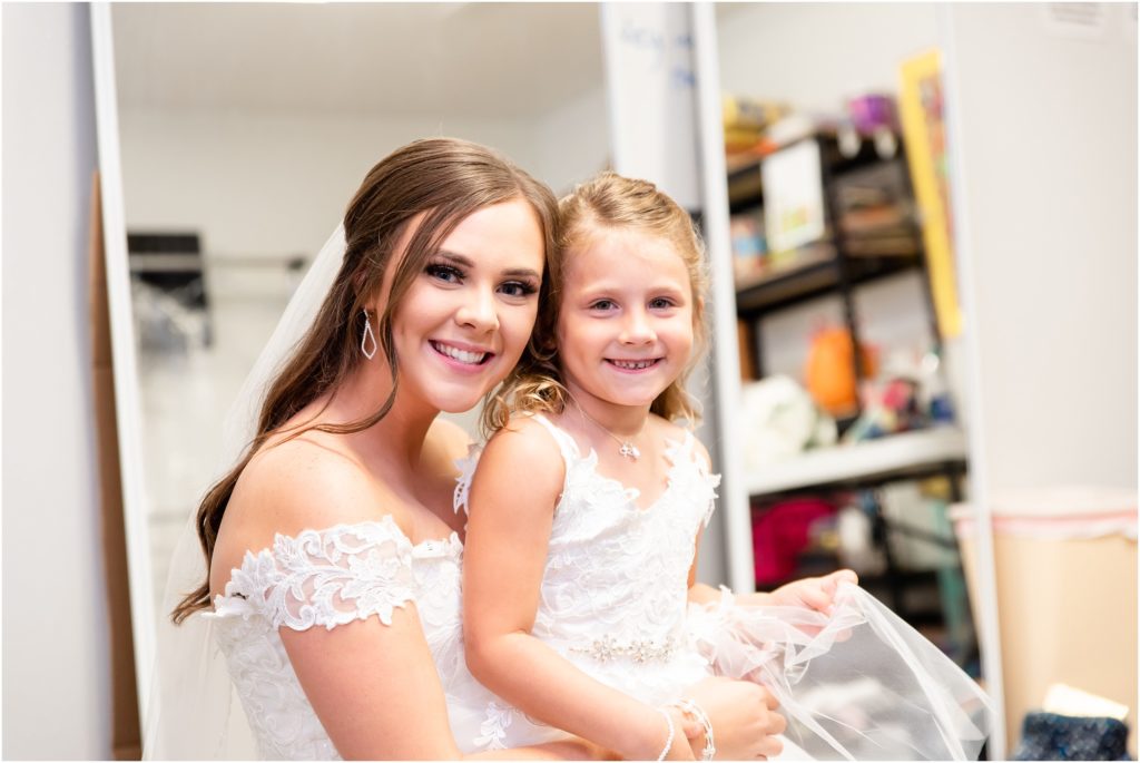 bride and flower girl smiling