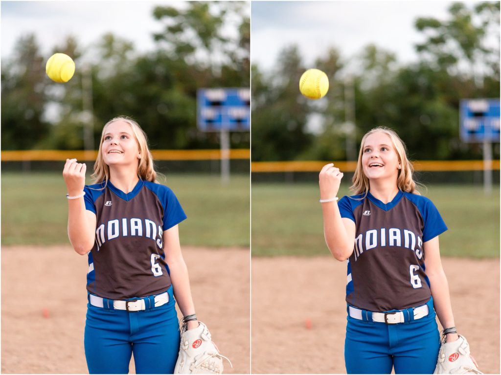 senior girl wearing softball uniform for Russellville Indians throwing softball in the air for senior photos