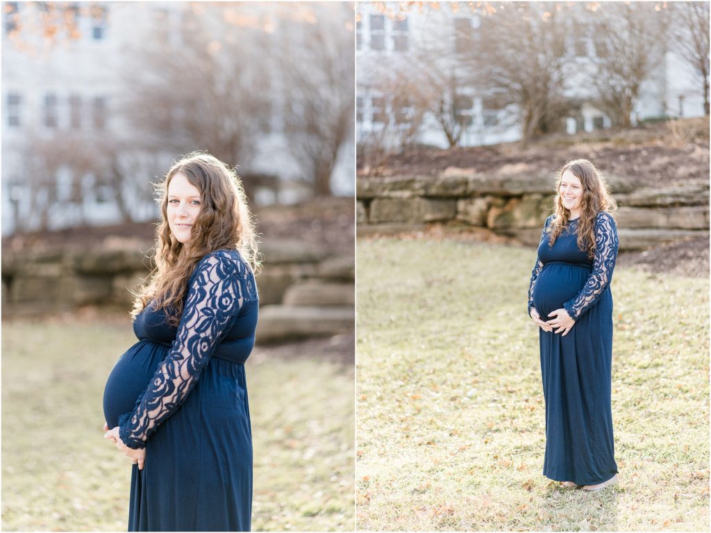 portraits of an expecting mother wearing a long navy maxi dress and holding her baby belly on grass of missouri capitol grounds