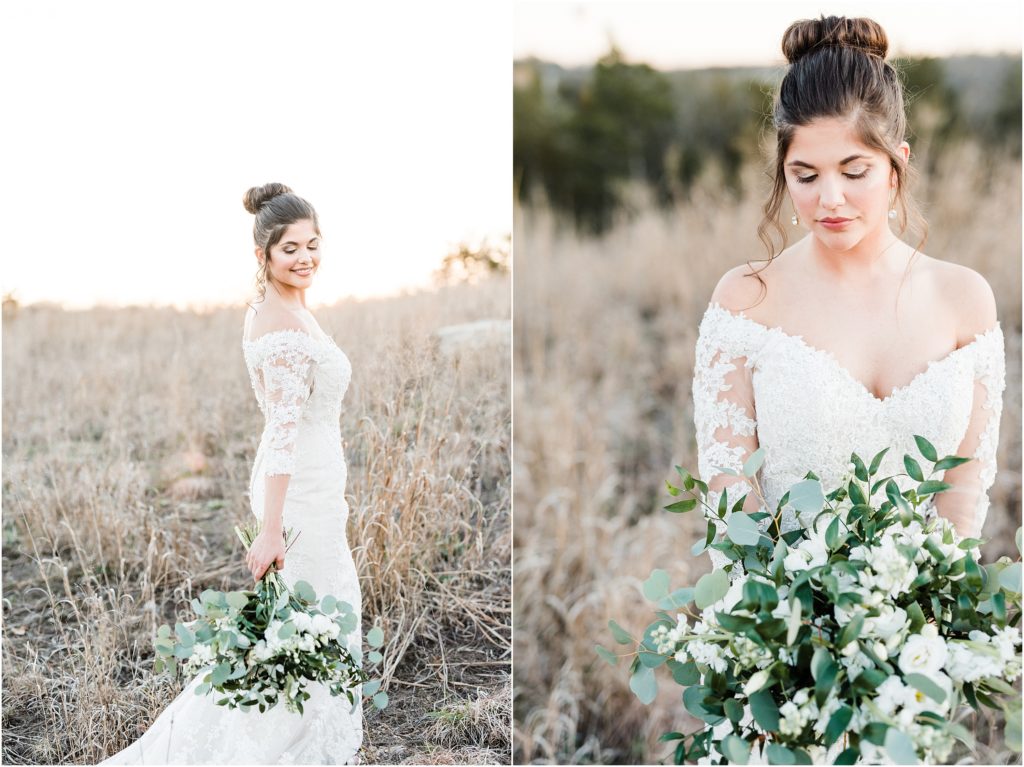 bride looking at white and green bouquet during bridal session in field at sunset