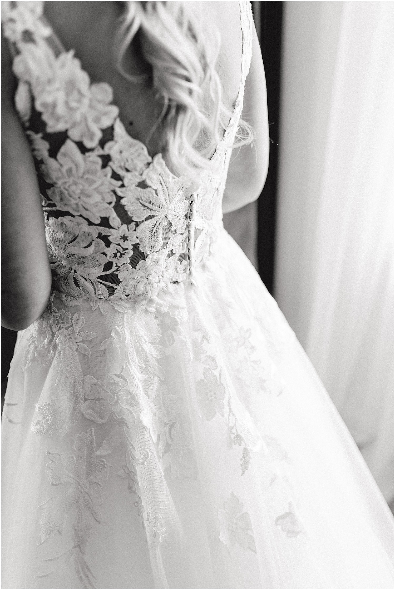 black and white image of back details of wedding gown