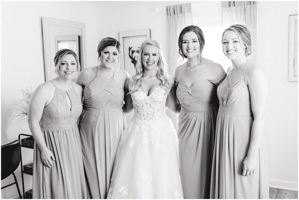 black and white image of bride and bridesmaids in getting ready room