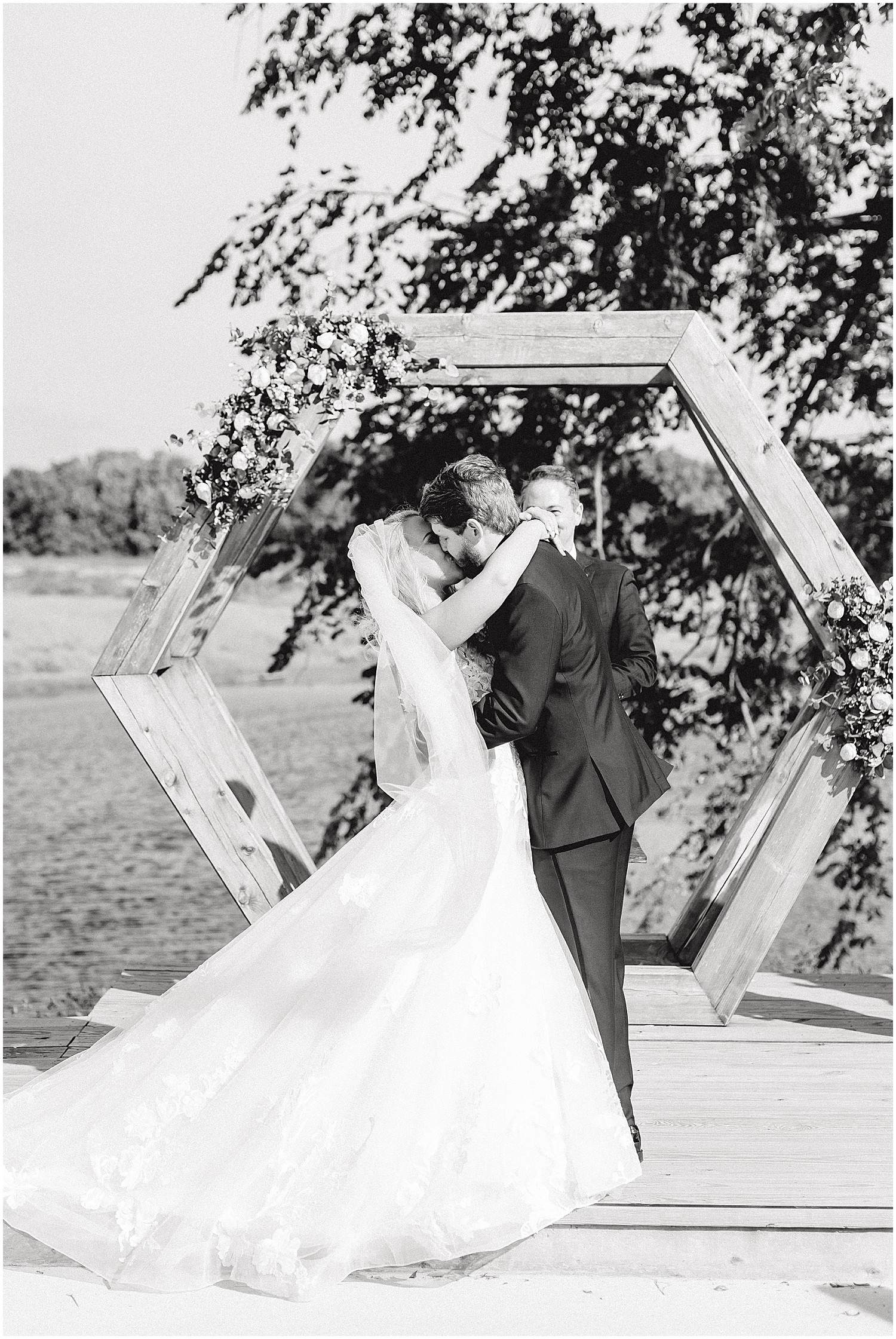 black and white image of bride and groom first kiss at altar at cooper's ridge wedding