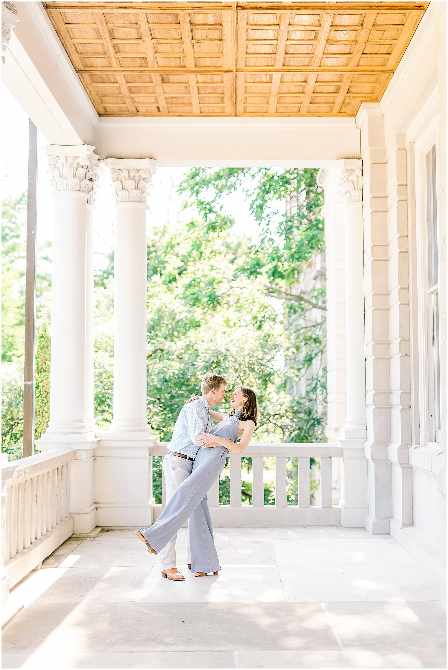 engaged couple on a large porch on mizzou campus jesse hall kissing and dancing