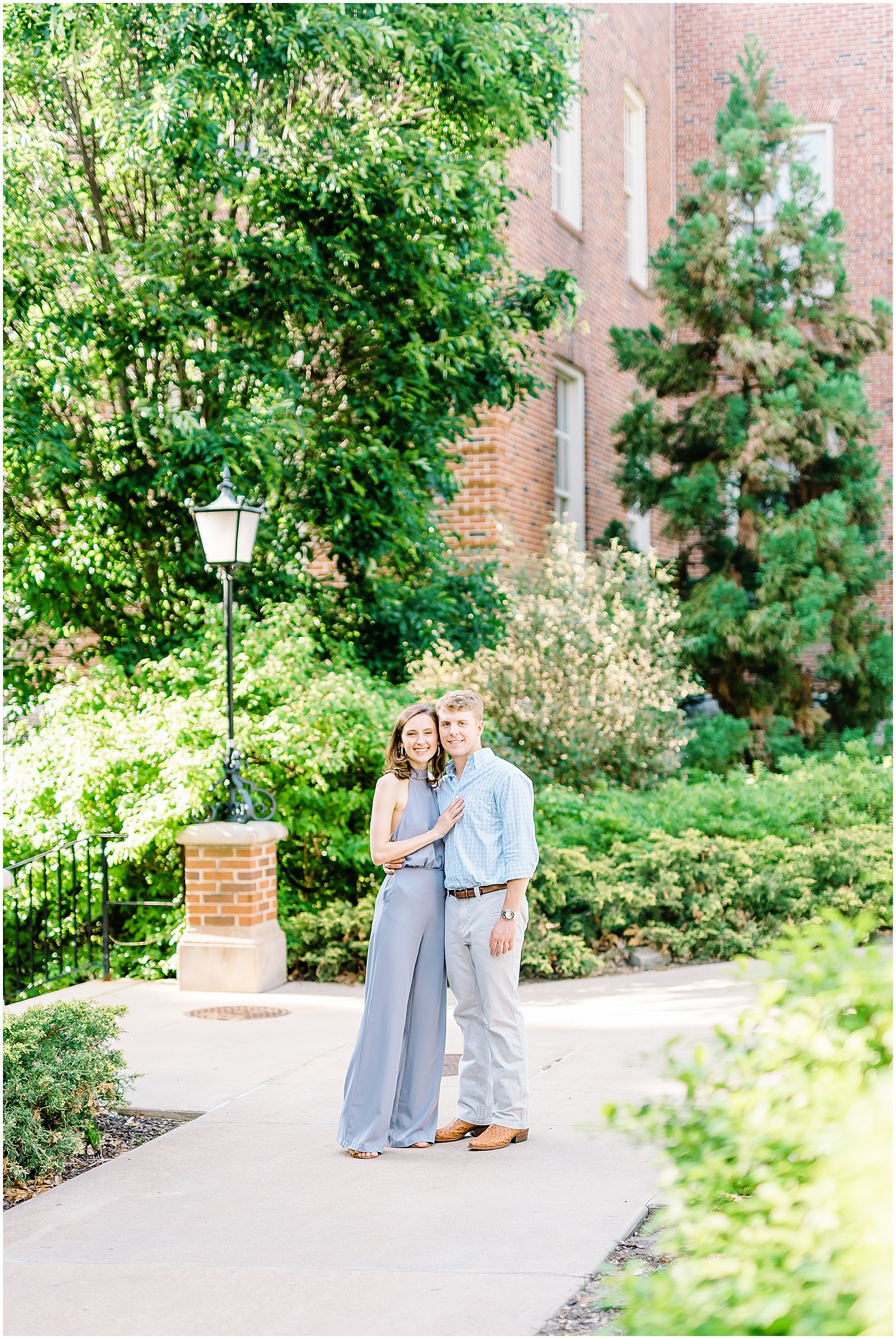 couple stands together surrounded by trees for mizzou campus engagement session