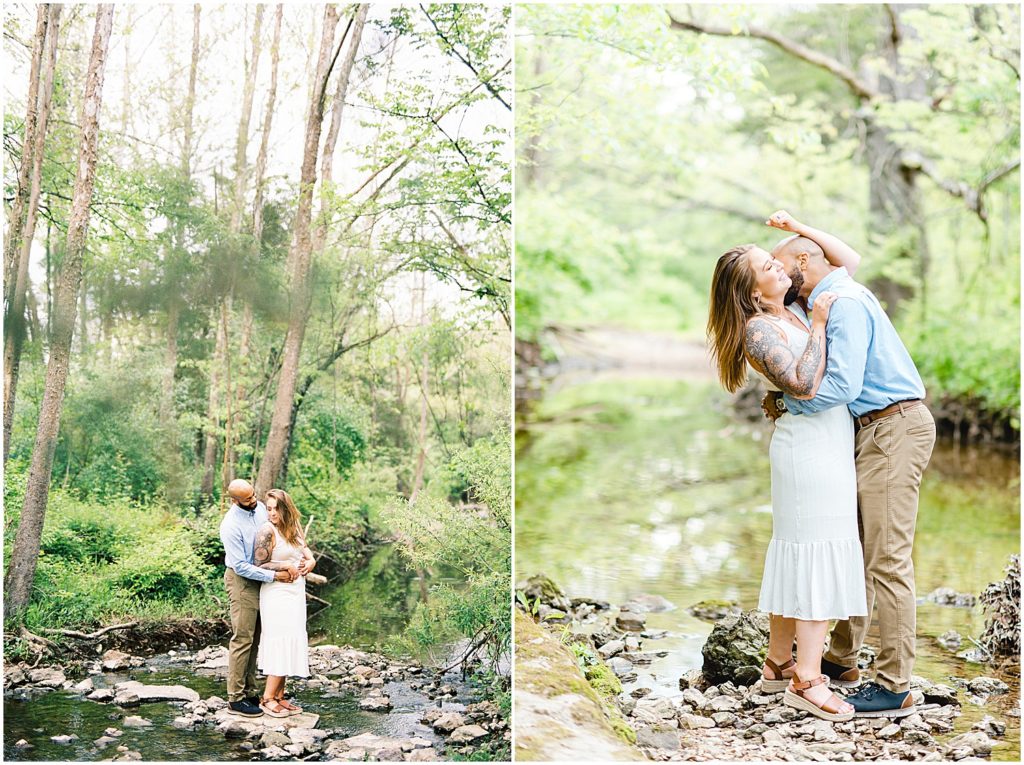 couple stands on rocks in creek and kiss for pictures