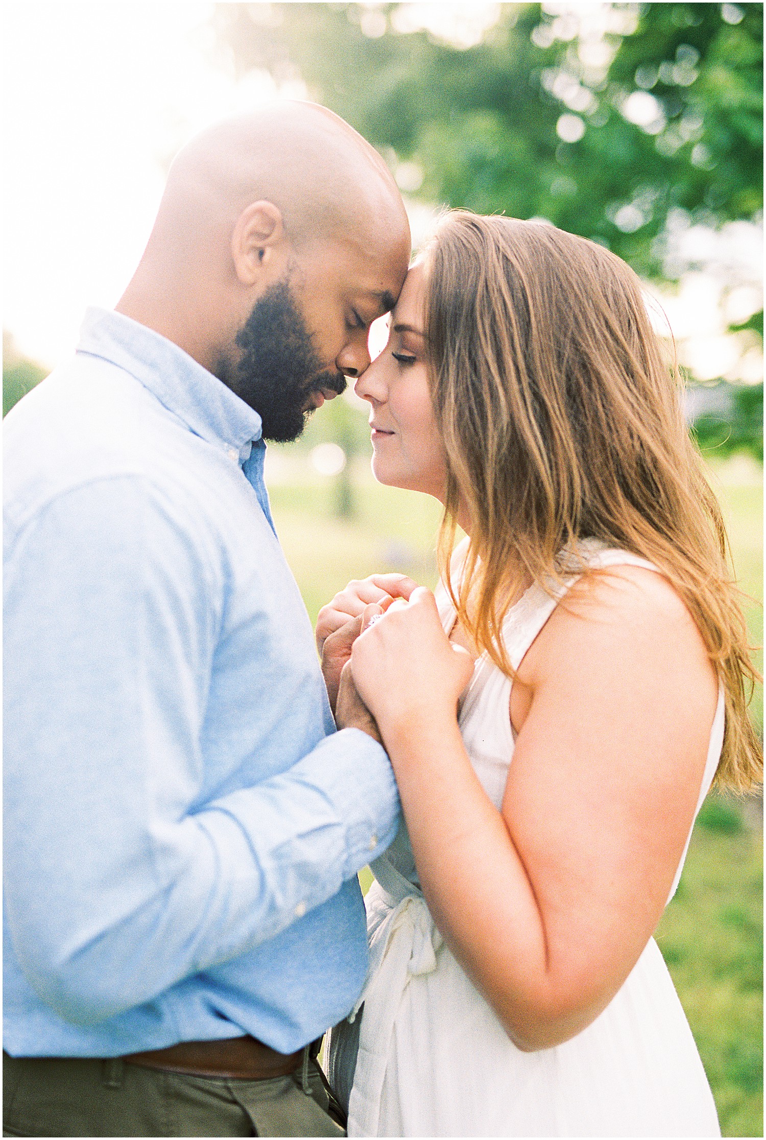 couple touches foreheads with eyes closed for jefferson city engagement session