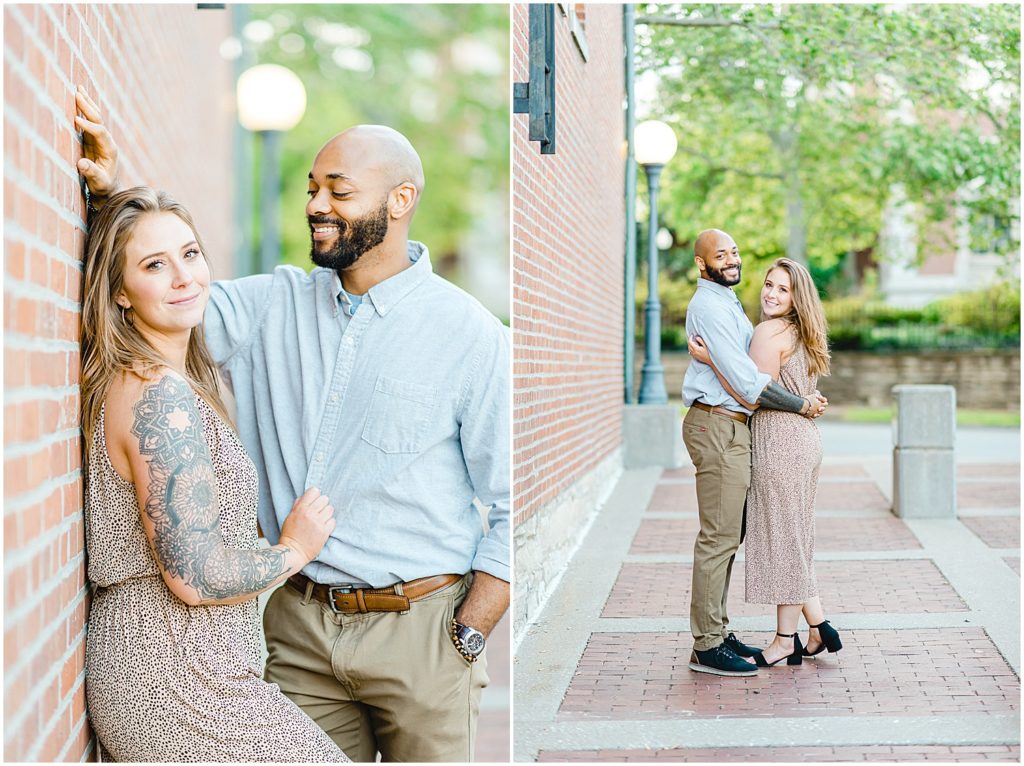 couple leans against brick wall during engagement photos in downtown jefferson city