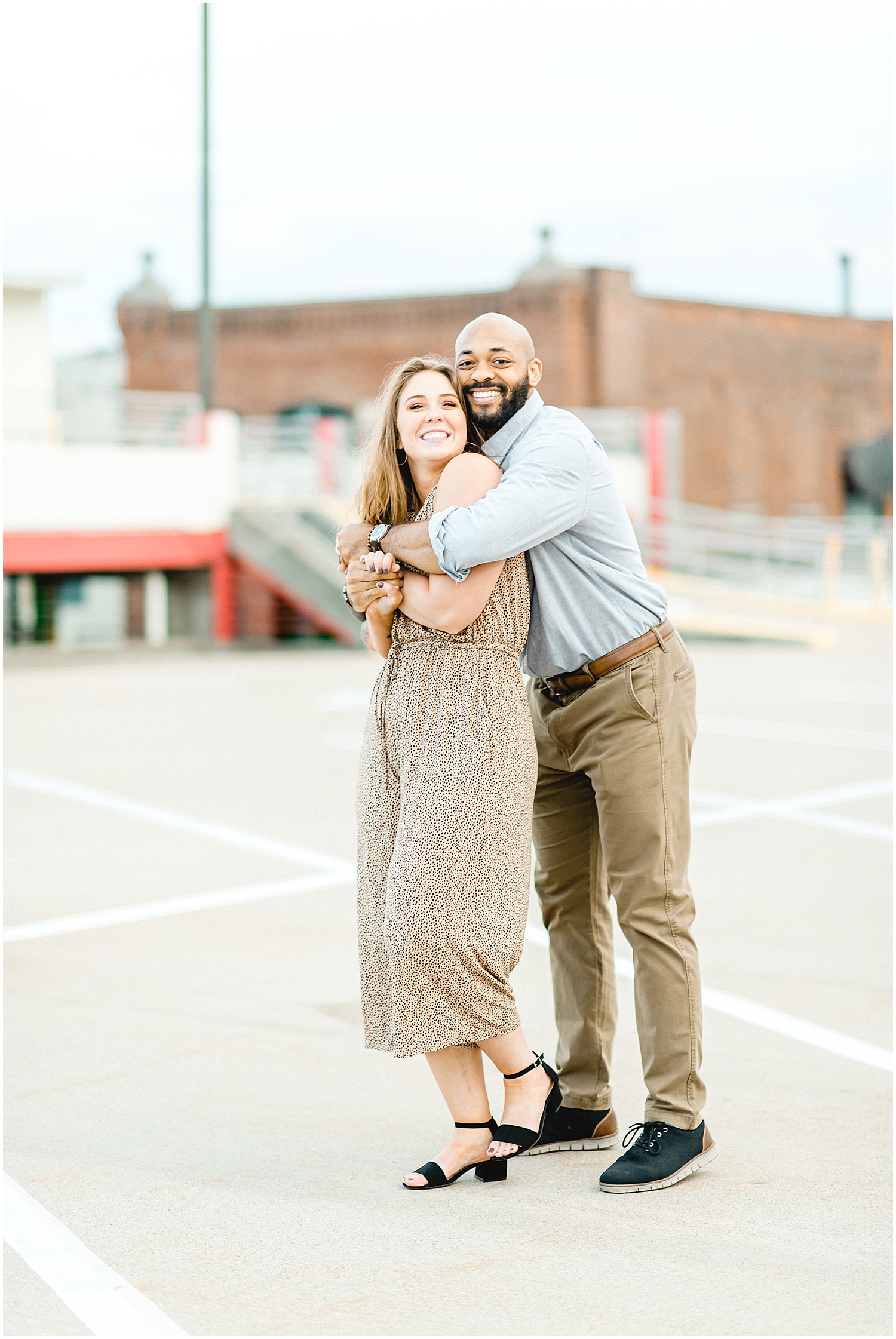 couple hugs each other during engagement session in downtown jefferson city