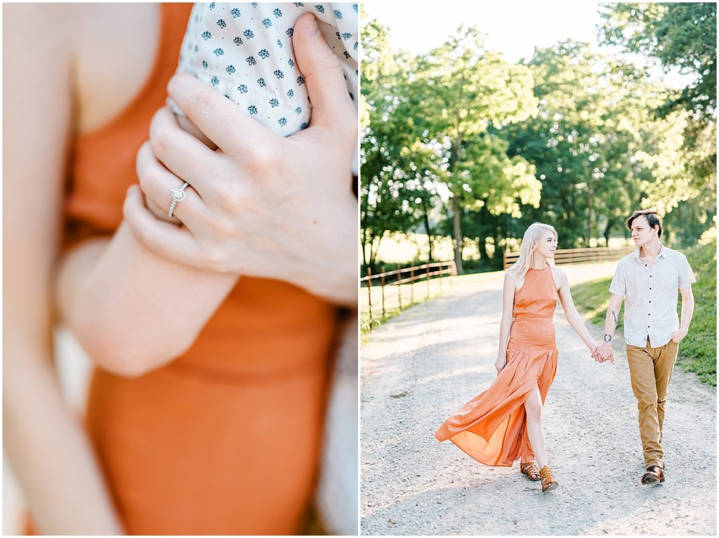 a couple walks on a gravel drive in the sunlight, her orange dress blows in the wind, for kempkers back 40 engagement session