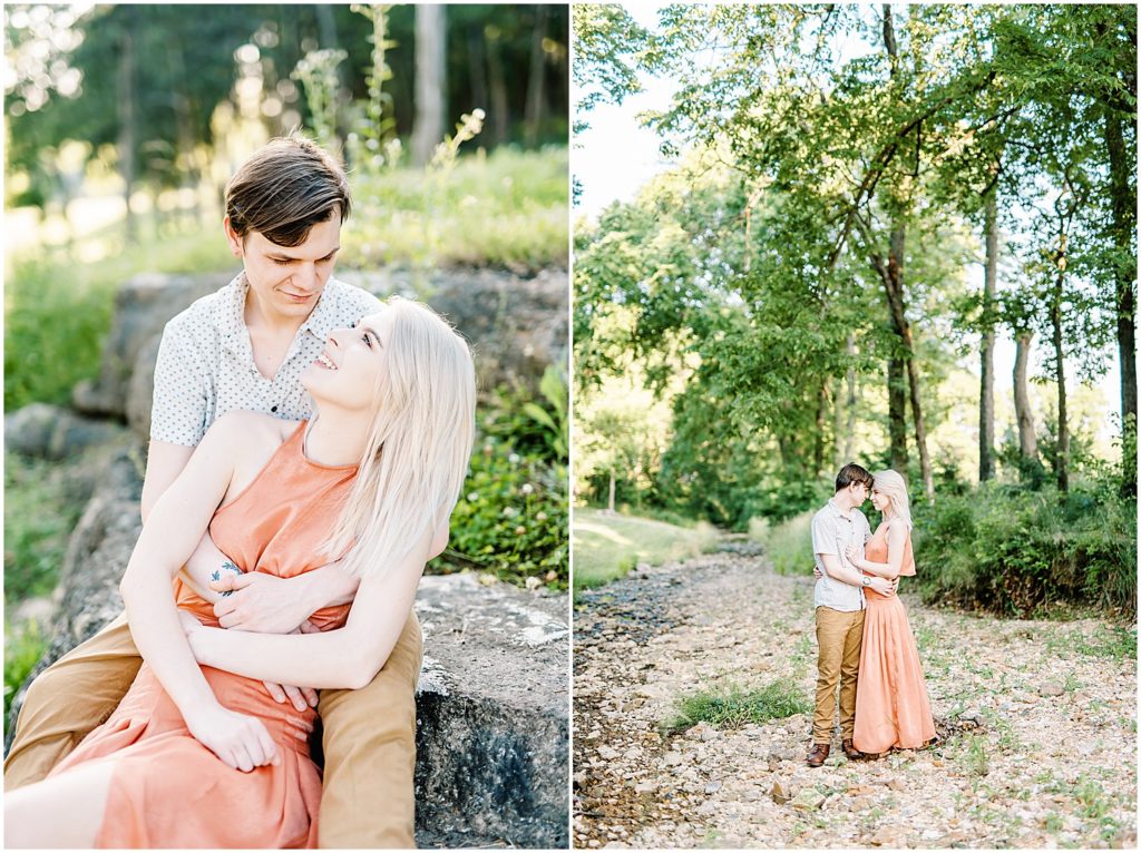 young couple hugs in creek bed under the trees at kempkers back 40 for engagement session