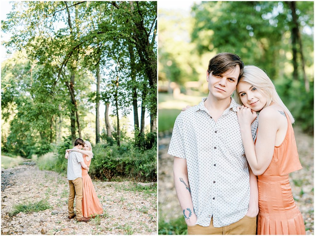 young couple holds each other in creek bed for engagement photos in missouri