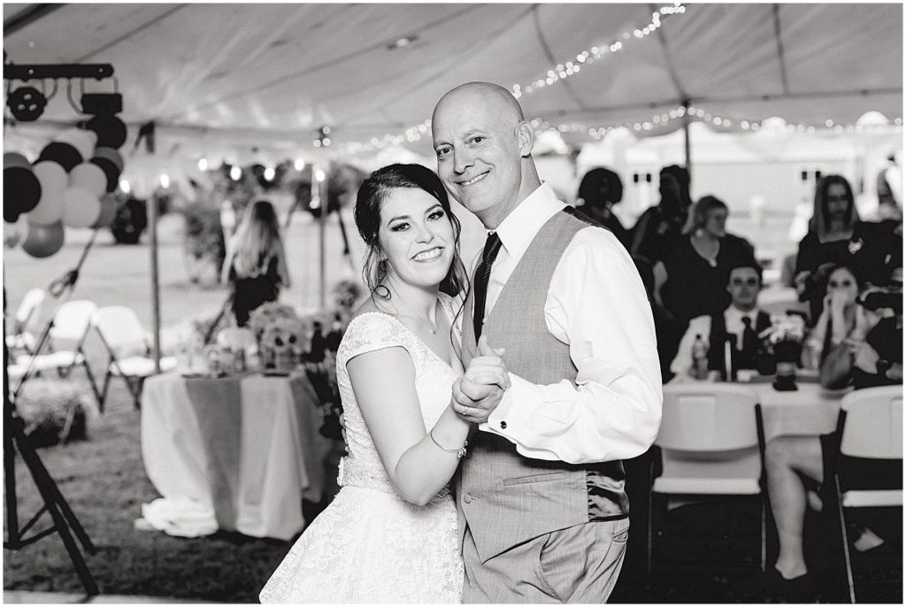 black and white image of bride dancing with her father at wedding reception