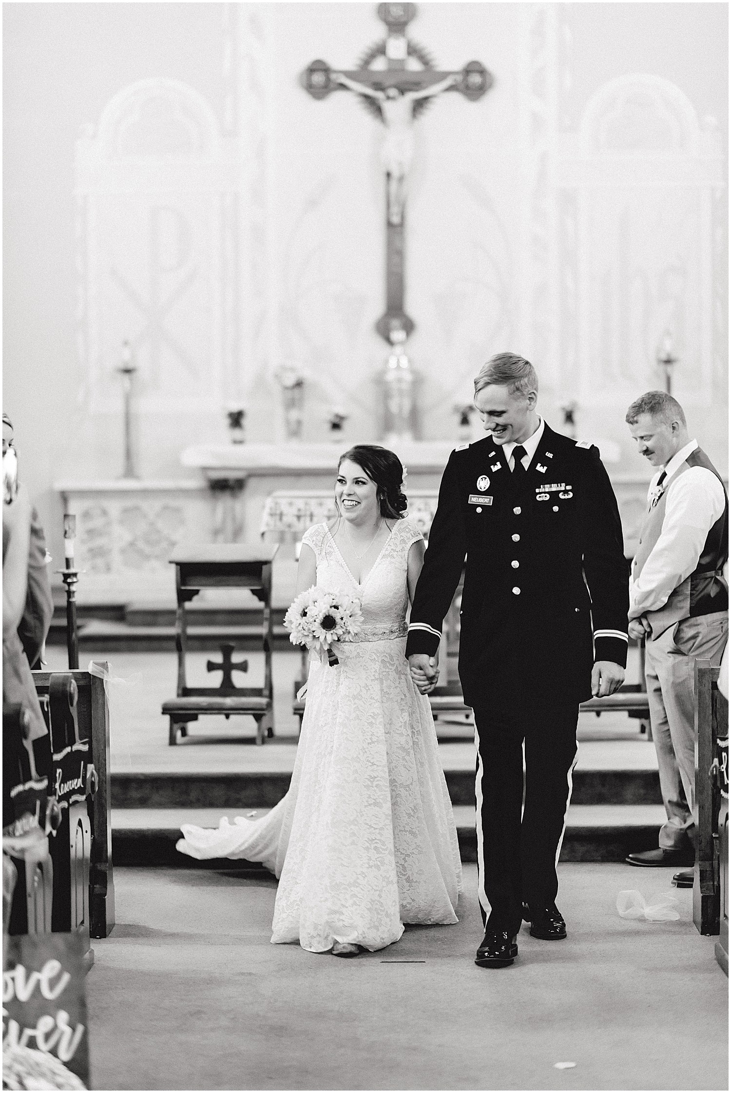 black and white image of bride and groom walking down the aisle together after wedding ceremony