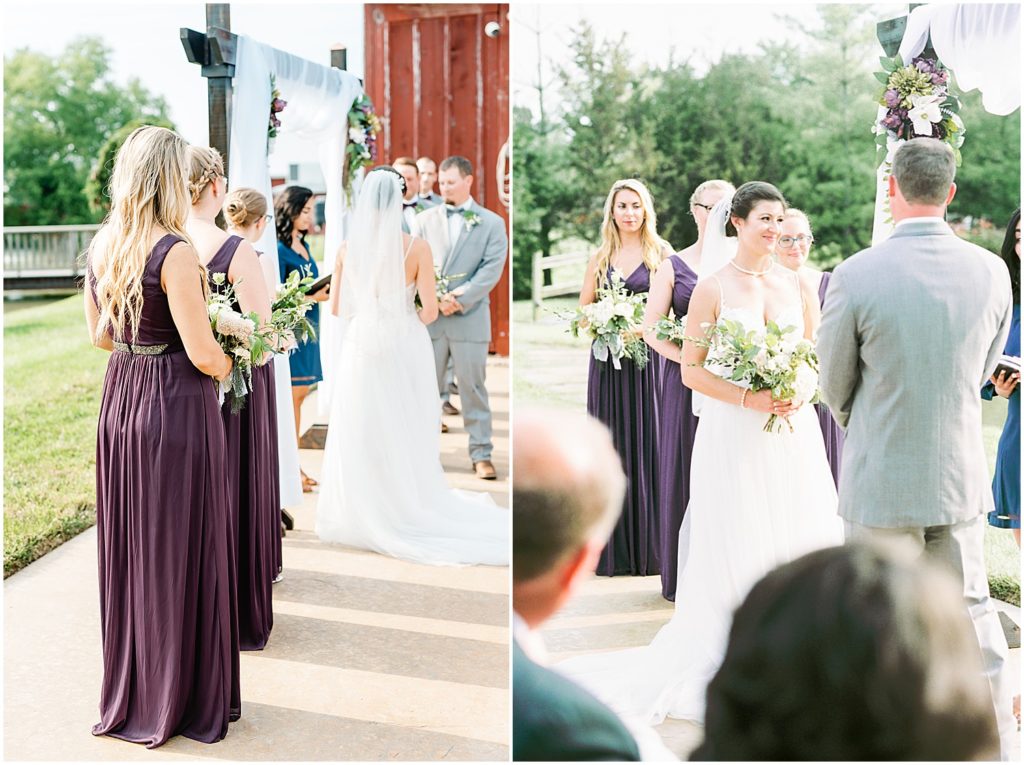a bride smiles at the officiant of her wedding ceremony while bridesmaids wearing purple dresses watch
