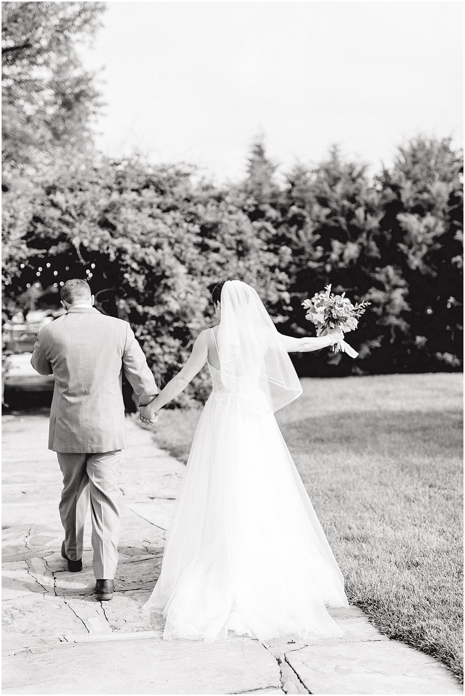 black and white image of bride and groom leaving the wedding ceremony