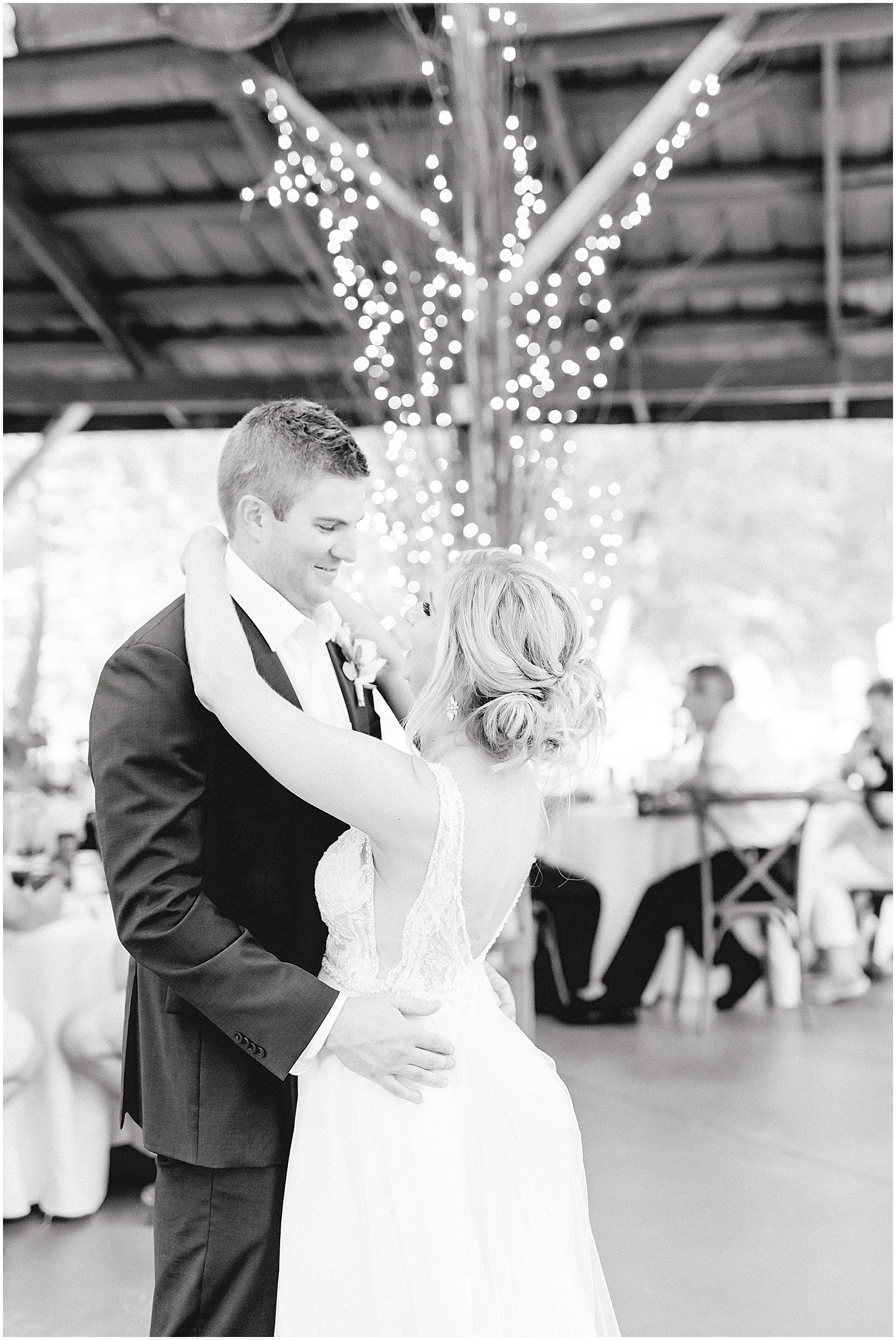 bride and groom first dance in black and white under covered patio at little piney lodge